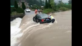 Police rescue three people from car trapped in floodwater