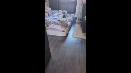 Toddler plays dress-up with scattered clothes in Vladivostok, Russia