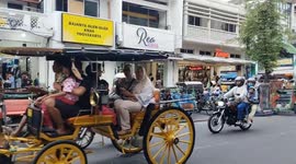 Traditional Horse Carriages Fill Busy Streets of Yogyakarta