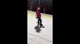 Woman skis steadily as another skier crashes beside her in Shandong, China