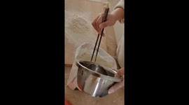 Chinese woman skipped the bowl and mixed dough in a flour bag