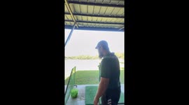 Beginner's powerful swing sends golf ball ricocheting onto roof