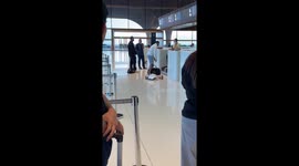 Tourist with overweight suitcase shouts at check-in staff