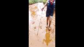 Hikers battle through thick 'milk tea' mud as they climb hillside