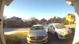 Royal Mail postman's trolley skids away down icy road