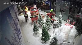 Moment thieves steal motorbikes from garage's Grinch window display