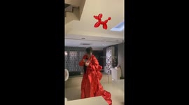 Timelapse Shows Woman Inflating Red Balloon Dog Halloween Costume Before Playful Ending