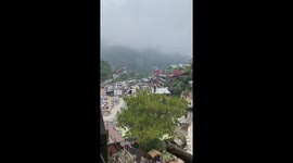 Tourist gets stuck while riding zipline bicycle above mountain park