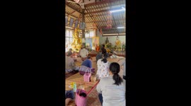 Pet dog relaxes on his back as Buddhist monk gives sermon