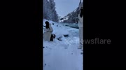 Terrifying ice surge caught on camera as tourists flee for their lives after calm river suddenly explodes into dangerous torrent