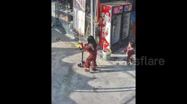 Girl falls off scooter, younger sister tries to help but ends up tripping her again