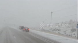 Blowing snow creates hazardous driving on US-40 near Parleys Summit in Utah, USA