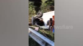 Minivan overturns on bend killing two passengers and injuring 13 more