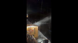 Nighttime snowblower operation clears heavy drifts along I-86 in Great Valley, New York, USA