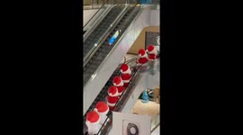 Santa and snowman dolls descend escalator in festive mall display in China