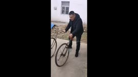 Man attempts to ride a detachable split bicycle in Jiangsu, China