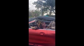 Dynasty-themed cosplay group dances in a convertible, Hainan, China