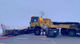 Snowploughs clear powder from airport runway in France