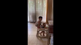 Children playfully share a baby walker in Davao City, Philippines