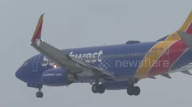 Plane lands through heavy fog at airport in Rochester, New York, USA