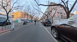 Minor bicycle and e-bike collision on busy highway in Beijing, China
