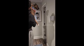 Boxer dog completing the wall challenge with excited human parents in the backgorund