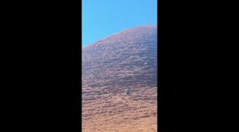 Two determined youngsters ride 100cc motorcycle up steep hill