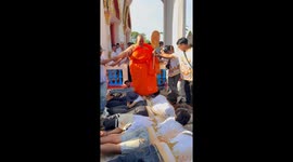 Obese Buddhist monk tramples over followers to 'bring them good luck'
