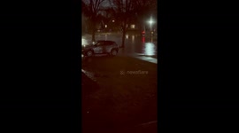 Heavy nighttime rain floods street in Chicago, Illinois, USA