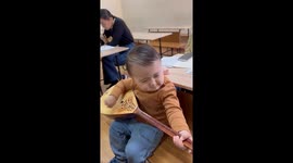 Toddler explores traditional dombra in Almaty, Kazakhstan