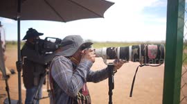 Sports photographer Luis Gutierrez with Canon long lens and Canon R1, 1DX camera and sports camouflage