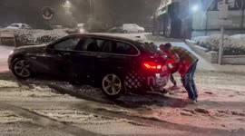 UK: Man Struggles To Push BMW Out Of Deep Snow During Storm Goretti