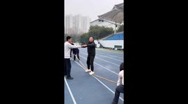 Unusual tug-of-war moment as commentator balances on rope in Zhejiang, China