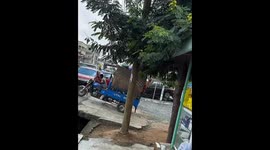 Overloaded tricycle tips backward on slope in Accra, Ghana
