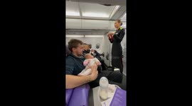 Three-month-old baby fascinated by safety briefing in Moscow, Russia