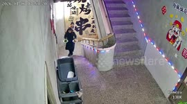 Woman slips while carrying food on stairs in Liaoning, China