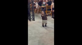 Young boy dances and drums in restaurant in Brazil