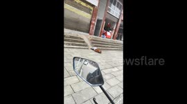 When boredom kicks in: Little boy uses pavement slope as slide
