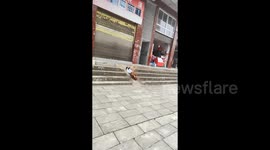 When boredom kicks in: Little boy uses pavement slope as slide