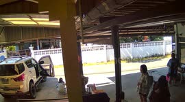 Family rush over to stop car rolling as husband lies underneath doing repairs