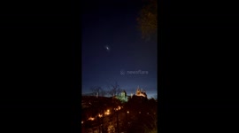 Falcon 9 launch rocket exhaust illuminates night sky over Prague Castle, Czech Republic
