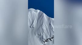 Daring skier sails down mountain peak before spectacular wipeout