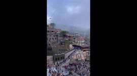 Crowd encourages nervous women struggling across bicycle zipline