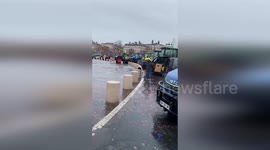 Farmers protest by surrounding Arc De Triomphe with tractors in Paris