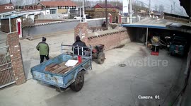 Man carefully parks a two-wheel tractor with utility trailer in Beijing, China