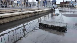 Heavy flooding after torrential rain hits Gants Hill in East London causing a drain to spew out water
