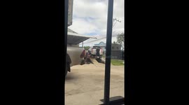Stuffed toy being washed alongside a car in Roxas, Philippines