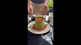Satisfying video of tiramisu reveal when banana leaf wrapping is removed