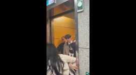 Crazed K Pop fans force their way into lift with singer