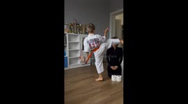 Young Karate Practitioner Kicks Mother's Head
